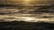 Stormy sea at Sunset, natural dramatic seascape. Sunset or Sunrise sun shining through golden waves, Ocean and sea Slow