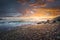 Stormy sea waves and foam at sunset. Marina di Cecina beach, Tuscany, Italy