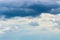 Stormy sky cloudscape with white cumulus rain clouds. Weather a sky peeps through thunderclouds, nature cloudy weather