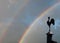 Stormy sky with rainbow, weather vane