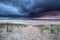 Stormy sky and showers over North sea beach