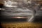 Stormy sky with tornado over field