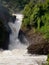 Stormy waterfall on the background of people