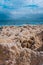 Stormy weather on the rocky coastline. Waves breaking against rocky shore. Dramatic cloudscape