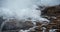 Stormy windy waves crashing on the rocks on a rocky coast