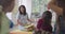 Storytime elementary or primary school teacher reading a story to a group of children in a daycare center.