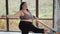 Stout over weight female doing exercises isolated. Happy body positive fat woman with dreadlocks doing stretching in the