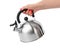 Stovetop whistling kettle in hand