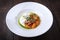 Straciatella with persimmon and tomatoes. Food on a white plate. Restaurant menu concept. Copy space. Flat lay.