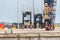 Straddle carrier lining up containers at port botany