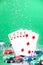 Straight combination under the water drops and falling poker chips against green background. Online gambling. Betting.