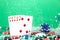 Straight combination under the water drops and falling poker chips against green background. Online gambling. Betting.