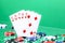 Straight combination under the water drops and falling poker chips against green background. Online gambling. Betting.