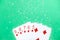 Straight combination under the water drops and falling poker chips against green background. Online gambling. Betting.