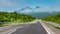 Straight empty asphalt automobile road in the mountains, travel concept