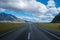 Straight empty highway leading into Aoraki-Mount Cook National Park.