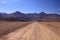 Straight endless dirt road in Atacama desert, Chile