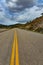 Straight flat asphalt road stretching into the distance beyond the horizon in Utah, US