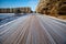 Straight gravel road running through a frost covered Wisconsin forest in a January afternoon