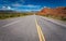 Straight highway cuts though the Abiquiu area with red rocks of fire.CR2