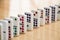 Straight Line of Colorful Dominoes on Wooden Floor