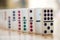 Straight Line of Colorful Dominoes on Wooden Floor