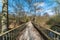 Straight lines of a deserted narrow pedestrian bridge over the valley of the Ossegem city park in Laeken