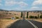 Straight open road surrounded by farms and fields in Australia. Road trip travel