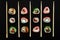 Straight parallel vertical lines of sushi and chopstick on black background.