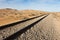 Straight railway tracks in the desert