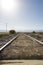 Straight train rails in the north of Argentina with blue sky