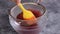 Straining Raspberry Puree Through a Mesh Sieve: Straining seeds out of fresh raspberry puree using a mesh strainer.