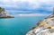 Strait between Portovenere town big stone promenade quay and Palmaria island rocks cliffs, Ligurian sea blue turquoise water