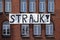 `Strajk` - a banner reading `strike` in Polish