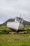 Stranded boat on a Scottish green field.