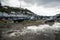 Stranded high and dry at low tide boats moored in tidal river.