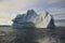 Stranded iceberg and ice near evening in arctic landscape, near Pond Inlet, Nunavut
