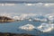 Stranded icebergs in the fog at the mouth of the Icefjord near Ilulissat. Nature and landscapes of Greenland.