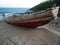 Stranded red Fishing boat on beach