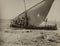 Stranded Sailboat and Group of People on the Beach in the 1940s