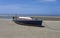 Stranded sailboat in the tideland sea