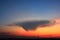 A strange cloud shape on blue sky background with sunrise