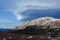 Strange Lenticular Clouds Over a Snow Covered Mountain Top