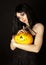 Strange woman in dress holding halloween pumpkin