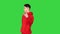 Strange young man in red hoody walking backwards on a Green Screen, Chroma Key.