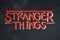 Stranger Things graffiti on grunge wall