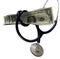 Strangled by Medical Costs. Dollars and a stethoscope isolated on a white background