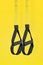 Straps training loop.Functional training equipment on yellow background. Sport accessories