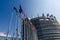 Strasbourg, France. August 2019.The entrance to the modern seat of the European parliament. A row of flagpoles with the flags of