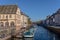 Strasbourg, water canal in Petite France area. timbered houses and trees in Grand Ile. Alsace, France. in the foreground water bus